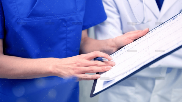 demo-attachment-1392-close-up-of-doctors-with-clipboard-at-hospital-PNAWFWS